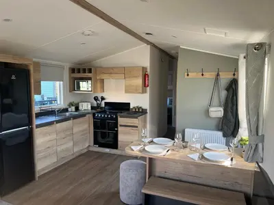 a kitchen with a table with plates on it at 2025 Willerby Ellerton Static Caravan in Morecambe
