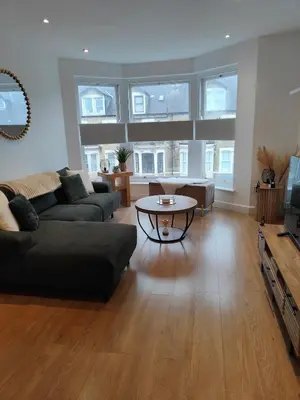 a living room with a couch and a table at luxury Maisonette near beach in Morecambe