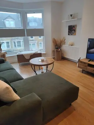 a living room with a couch and a table at luxury Maisonette near beach in Morecambe