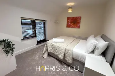 a bedroom with a bed and a window at Sandringham & Spa Villa in Thornton