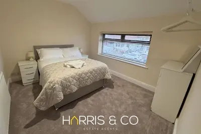 a bedroom with a bed and a window at Sandringham & Spa Villa in Thornton