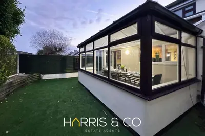 a large glass house with a green lawn at Sandringham & Spa Villa in Thornton