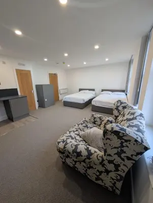 a room with two beds and a couch in it at Park Lodge Preston in Preston