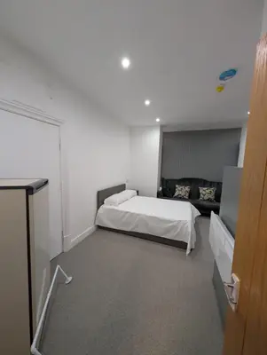 a bedroom with a bed and a couch in it at Park Lodge Preston in Preston
