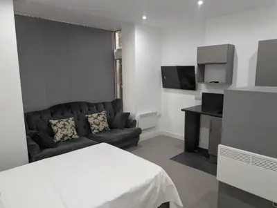 a living room with a couch and a table at Park Lodge Preston in Preston
