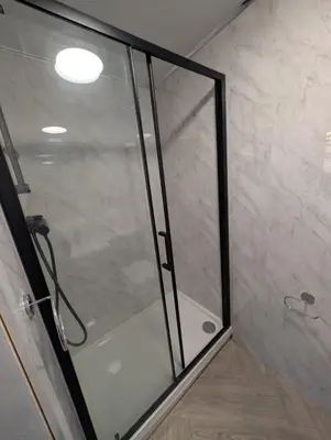 a shower with a glass door in a bathroom at Park Lodge Preston in Preston