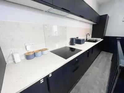 a kitchen with a sink and a counter top at Serenity Wembley in Blackpool
