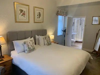 a bedroom with a large white bed with pillows at The Gaydon in Lytham St Annes