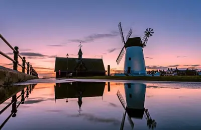a group of windmills with a sunset in the background at The Gaydon in Lytham St Annes