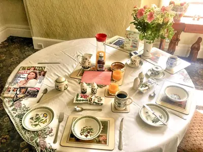 a white table with plates and dishes on it at The Gaydon in Lytham St Annes