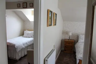 a small room with a bed and a small bedroom at The Gaydon in Lytham St Annes