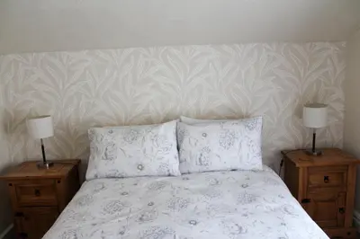 a bedroom with a bed with two lamps on night stands at The Gaydon in Lytham St Annes