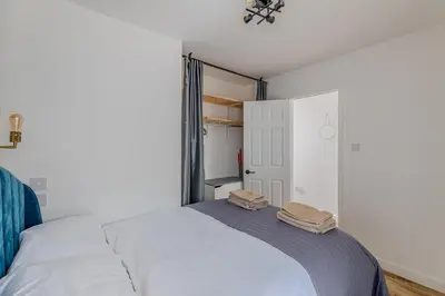 a bedroom with a bed with two towels on it at Chic 1BHK in West London in Lytham St Annes