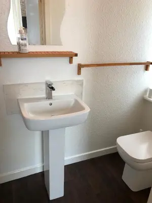 a bathroom with a white sink and a toilet at West Vale Villa in Blackpool