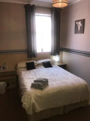 a bedroom with a bed with towels on it at West Vale Villa in Blackpool