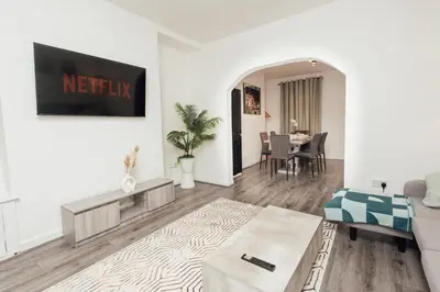 a living room with a couch and a table at Stylish 3 Bed Home with 4 beds- 5 Min walk From Anfield Stadium in Liverpool