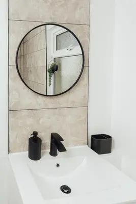 a bathroom with a mirror over a white sink at Stylish 3 Bed Home with 4 beds- 5 Min walk From Anfield Stadium in Liverpool