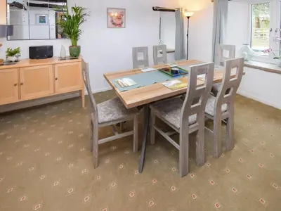 a dining room table and chairs in a room at The Old Farm House in Beetham