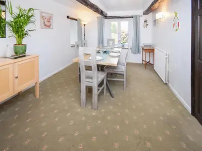 a dining room with a table and chairs at The Old Farm House in Beetham