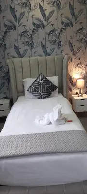 a bed with white towels on top of it at The Dreamcatcher Hotel in Blackpool