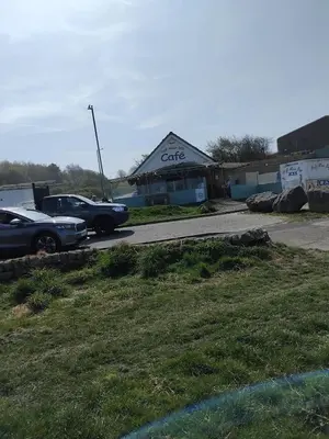 a car dealership with cars parked in a parking lot at Our Sea View - Heysham in Heysham