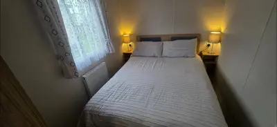 a bed in a small room with a window at Our Sea View - Heysham in Heysham