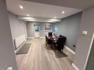 a dining room with a table and chairs at Rose Cottage by Sasco in Blackpool
