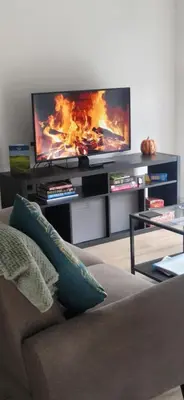 a living room with a couch and a flat screen tv at Sarah's Woodland Liverpool Stays in Waterloo
