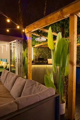 a living room with a couch and some plants at The Secret Garden Glamping Lancashire in Skelmersdale