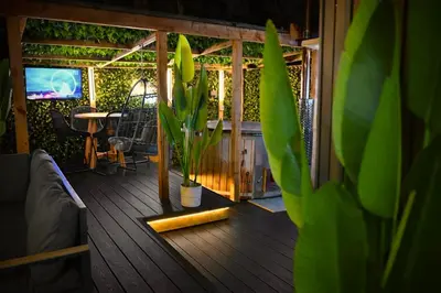 a house with a porch with a table and a plant at The Secret Garden Glamping Lancashire in Skelmersdale