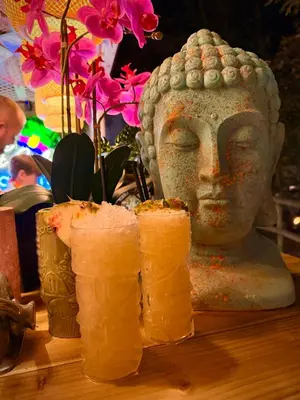 a statue of a head on a table with sushi at The Secret Garden Glamping Lancashire in Skelmersdale