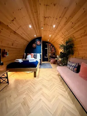 a room with a bed and a couch at The Secret Garden Glamping Lancashire in Skelmersdale
