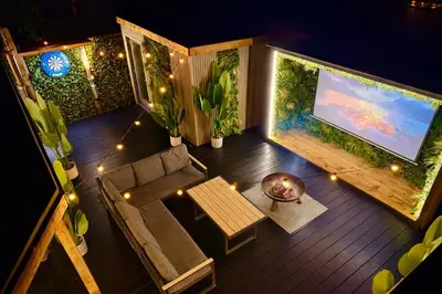 an overhead view of a living room with a flat screen tv at The Secret Garden Glamping Lancashire in Skelmersdale