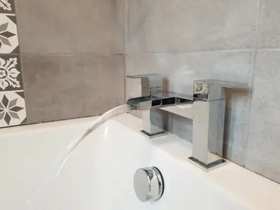 a bathroom sink with a water faucet at Liverpool Redwood house in Liverpool