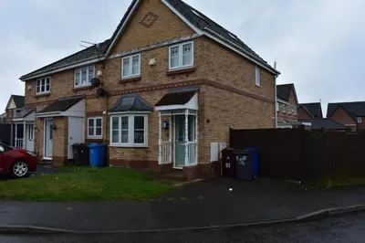 a brick house with a car parked in front of it at Liverpool Redwood house in Liverpool
