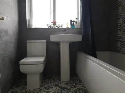 a bathroom with a toilet and a sink and a tub at Liverpool Redwood house in Liverpool