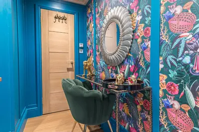 a room with a mirror and a green chair at Hidden Hills Luxury Glamping in Arkholme
