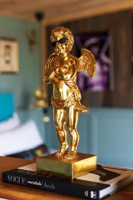 a gold trophy with sunglasses on top of a book at Hidden Hills Luxury Glamping in Arkholme