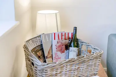 a basket with books and wine bottles on a table at 3 Bed in Baycliff oc-b34152 in Baycliff