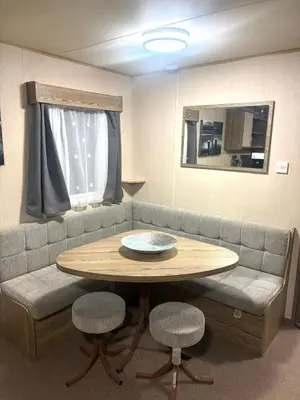 a room with a couch and a table and chairs at Marton Mere 8 Berth Caravan in Blackpool