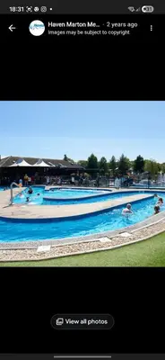 a picture of a swimming pool with people in it at Marton Mere 8 Berth Caravan in Blackpool