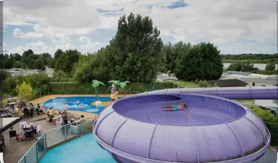 a large swimming pool with people in a pool at Marton Mere 8 Berth Caravan in Blackpool