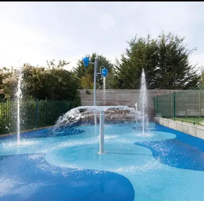 a fountain in a pool with blue water at Marton Mere 8 Berth Caravan in Blackpool