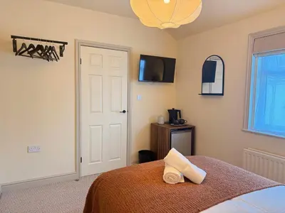 a bedroom with a bed with a white towel on it at The Meridian in Southport