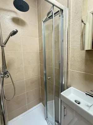 a bathroom with a shower and a sink at The Meridian in Southport