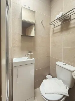 a bathroom with a toilet and a sink at The Meridian in Southport