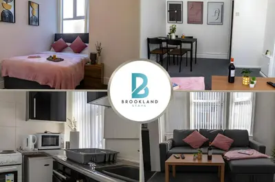 a kitchen and a living room with a bed in a room at 1BR Apartment in Blackpool l Sleeps 4, Fully Furnished in Blackpool