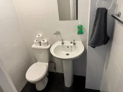 a white bathroom with a toilet and a sink at 1BR Apartment in Blackpool l Sleeps 4, Fully Furnished in Blackpool