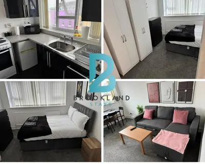 a kitchen and a living room with a couch at 1BR in Blackpool l Sleeps 4, Wi-Fi & Full Kitchen in Blackpool