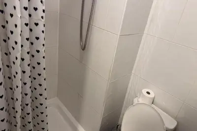 a bathroom with a shower with a toilet and a shower curtain at 1BR in Blackpool l Sleeps 4, Wi-Fi & Full Kitchen in Blackpool